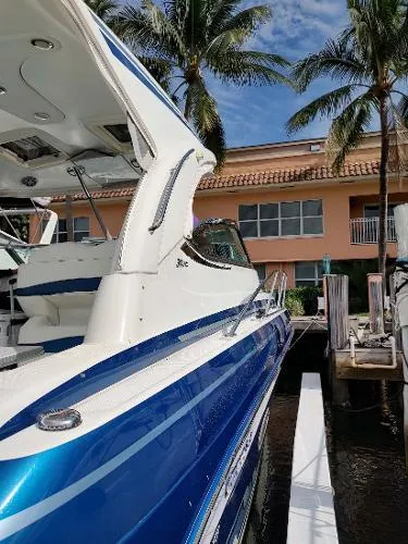 Slide: The Image of 2017 Formula 37 PC boat docked near palm trees and a waterfront building. - 6