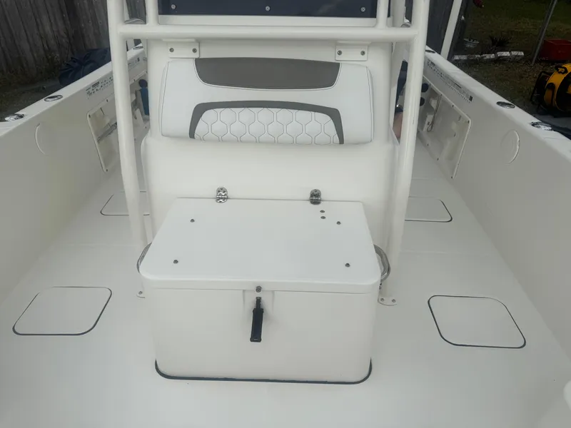 Slide: The Image of 2019 World Cat 230 CC boat interior with seating and storage compartment. - 13