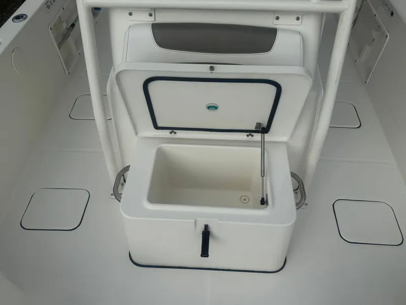 Slide: The Image of 2019 World Cat 230 CC boat interior with open storage compartment. - 14