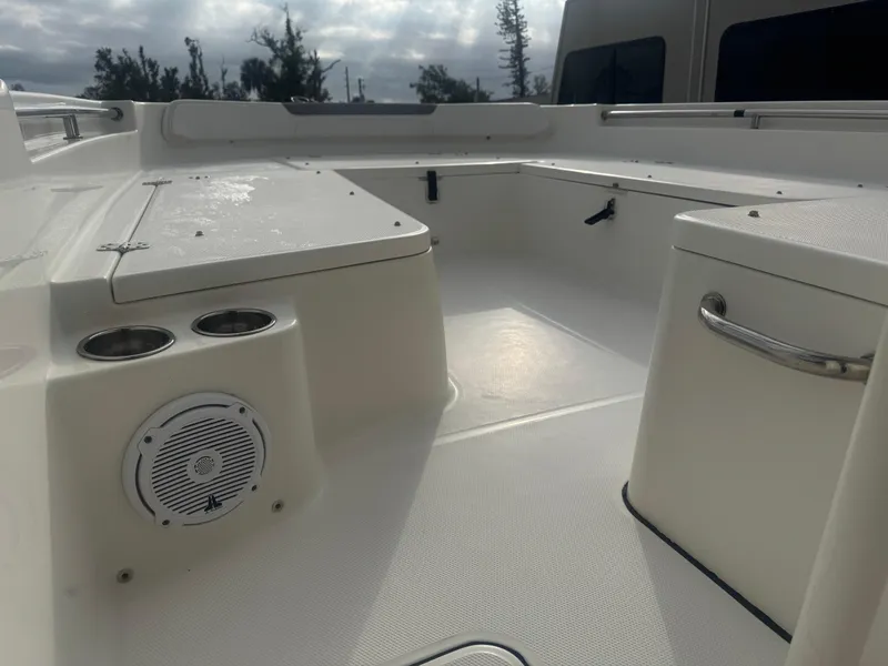 Slide: The Image of 2019 World Cat 230 CC boat interior with seating, cup holders, and speaker. - 15