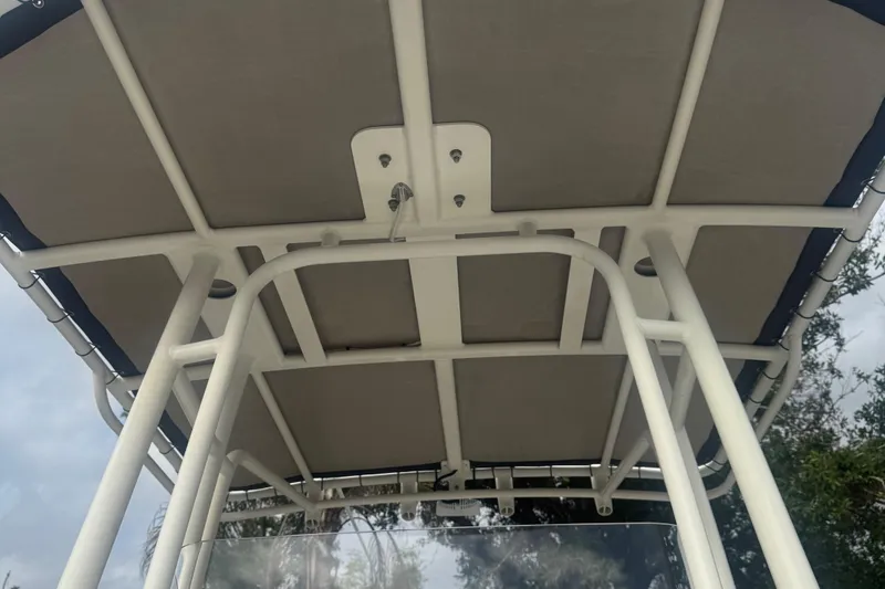 Slide: The Image of 2019 World Cat 230 CC boat canopy viewed from below, showcasing sturdy frame and design. - 16