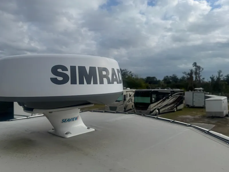 Slide: The Image of Simrad radar on 2019 World Cat 230 CC boat, with RVs in the background under cloudy skies. - 17