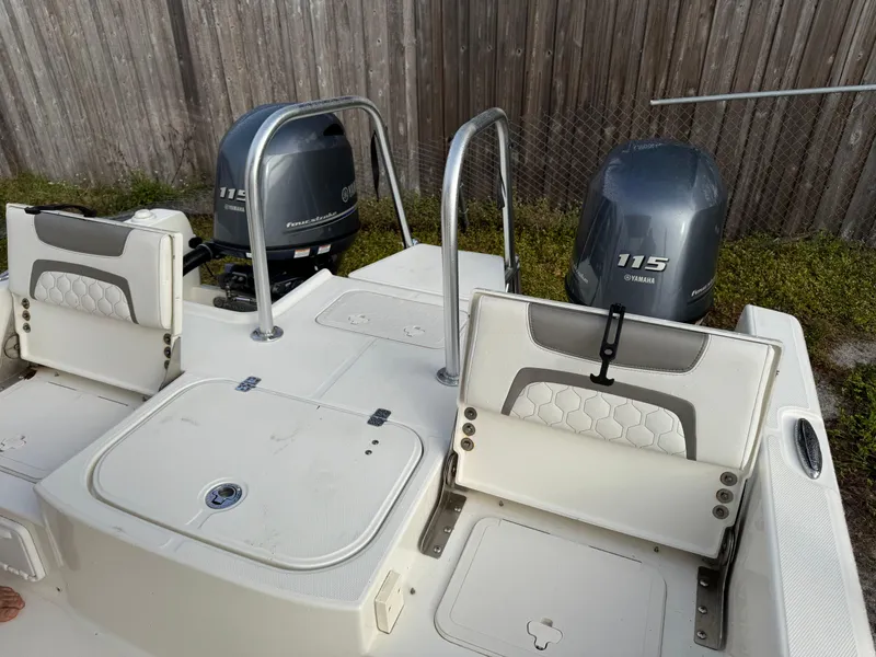 Slide: The Image of 2019 World Cat 230 CC boat with twin 115 horsepower engines, rear seating, and storage compartments. - 4