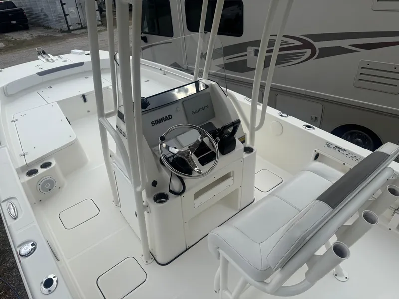Slide: The Image of 2019 World Cat 230 CC boat interior with steering console and seating. - 5