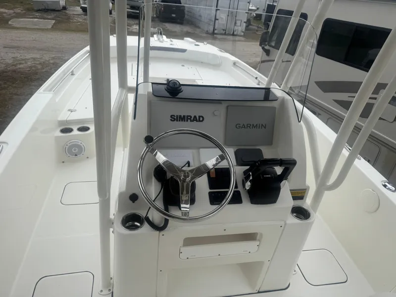 Slide: The Image of 2019 World Cat 230 CC boat cockpit with Simrad and Garmin navigation systems. - 6