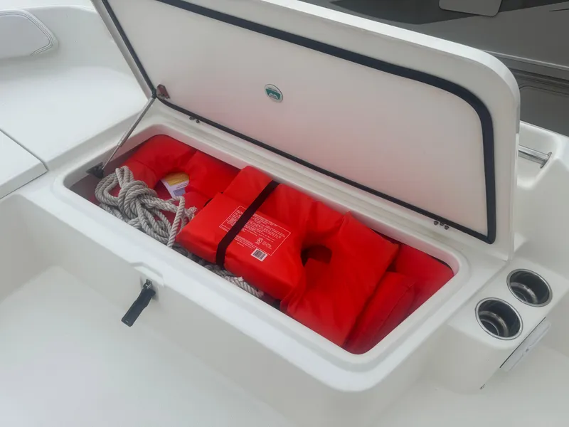 Slide: The Image of Open storage compartment on 2019 World Cat 230 CC boat with life jackets and rope. - 9