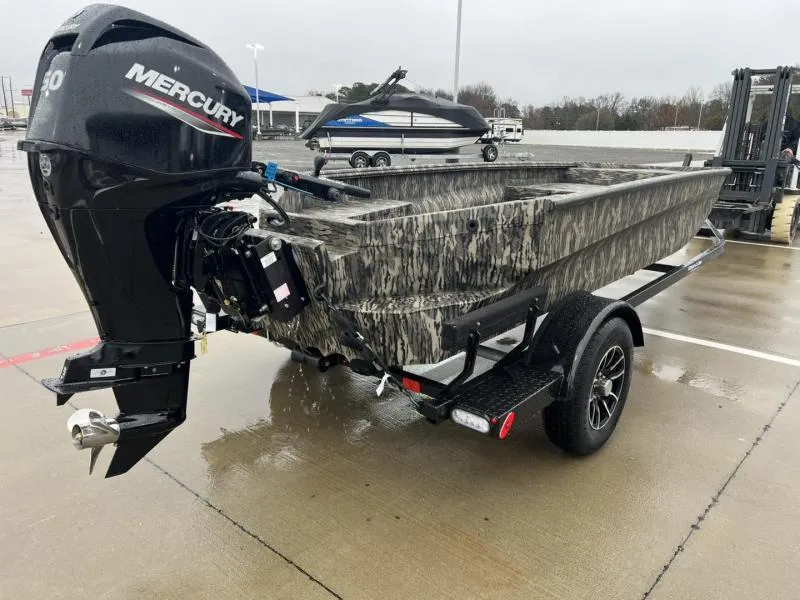 Slide: The Image of 2025 Havoc Boats 1656 VJST with Mercury engine on trailer, parked outdoors. - 3