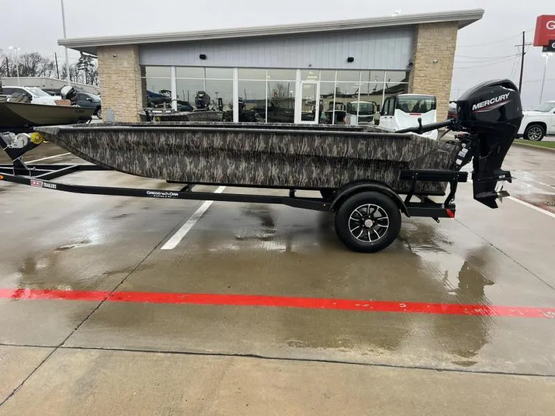 Slide: The Image of 2025 Havoc Boats 1656 VJST on trailer, parked outside dealership on wet pavement. - 6