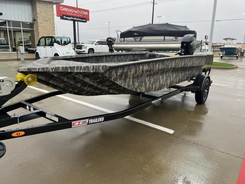 Slide: The Image of 2025 Havoc Boats 1656 VJST on trailer, parked at dealership on a rainy day. - 7