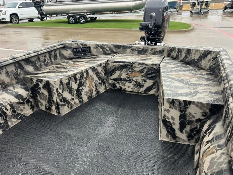 Slide: The Image of 2025 Havoc Boats 1656 VJST with camouflage interior, parked on wet pavement. - 10