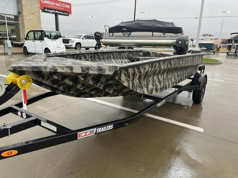 Slide: The Image of 2025 Havoc Boats 1656 VJST on trailer, camo design, parked outdoors. - 7