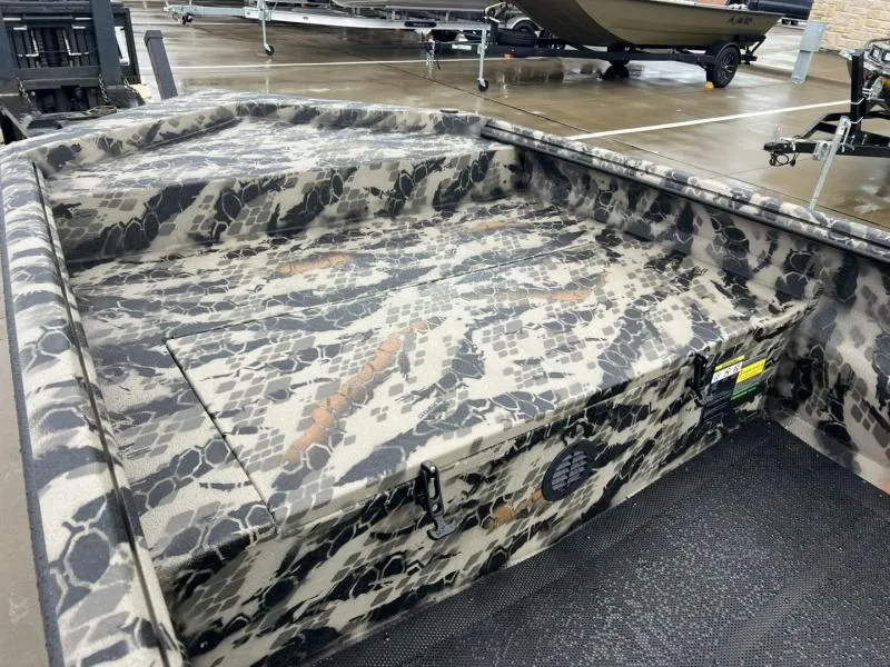 Slide: The Image of 2025 Havoc Boats 1656 VJST with camouflage interior design, parked on a wet surface. - 9