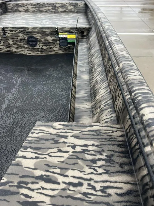 Slide: The Image of 2025 Havoc Boats 1656 VJST interior with camouflage pattern and textured flooring. - 12