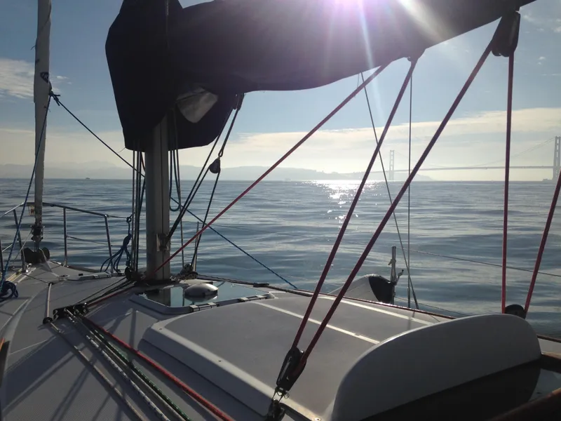 Slide: The Image of Sailing on Jeanneau Sun Odyssey 32i, 2003 model, with sunlit ocean view. - 15