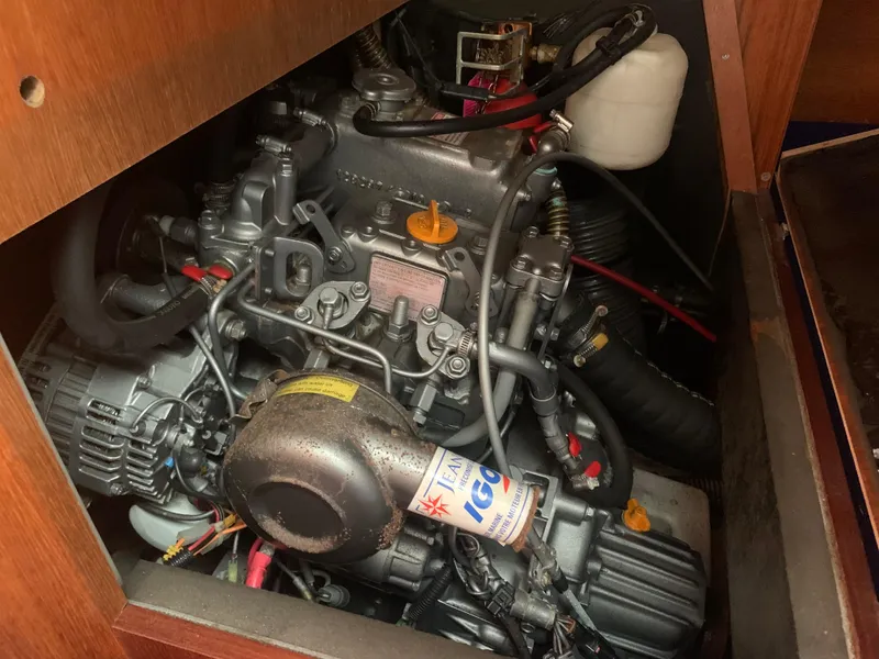 Slide: The Image of Engine compartment of a 2003 Jeanneau Sun Odyssey 32i sailboat, showcasing detailed mechanical components. - 18