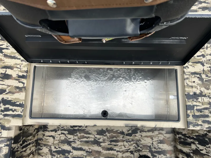 Slide: The Image of Open storage compartment in 2025 Excel 1651 River Warrior boat with camouflage interior. - 10