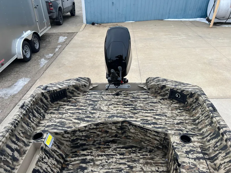 Slide: The Image of 2025 Excel 1651 River Warrior boat with camouflage interior and outboard motor. - 14