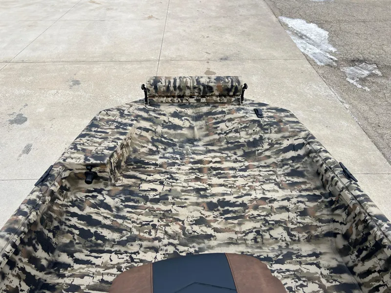Slide: The Image of 2025 Excel 1651 River Warrior boat with camouflage interior design on concrete surface. - 7