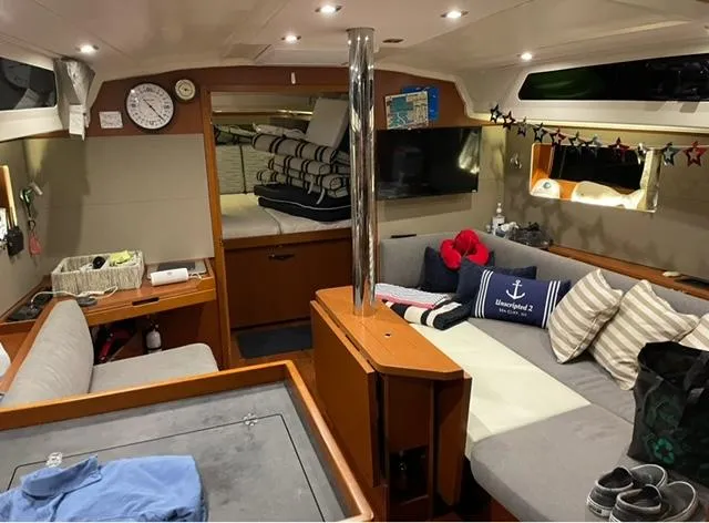 Slide: The Image of Interior of 2018 Beneteau Oceanis 41.1 yacht, featuring cozy seating and nautical decor. - 12