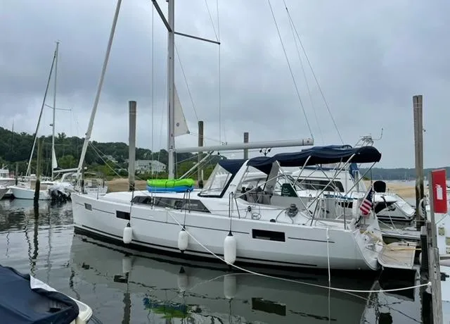 Slide: The Image of 2018 Beneteau Oceanis 41.1 sailboat docked in a marina, overcast sky. - 2