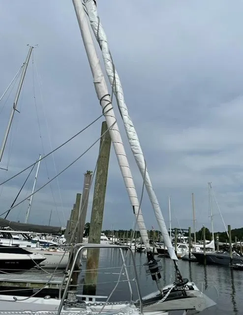 Slide: The Image of 2018 Beneteau Oceanis 41.1 sailboat docked in a marina under cloudy skies. - 6