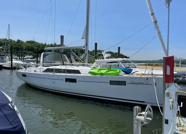 Slide: The Image of 2018 Beneteau Oceanis 41.1 sailboat docked in a marina, clear sky background. - 8