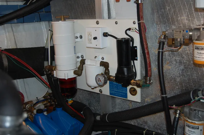 Slide: The Image of Engine room of 2002 Eagle Pilothouse with fuel filtration system and gauges. - 15