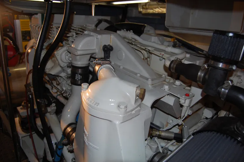 Slide: The Image of Engine room of a 2002 Eagle Pilothouse boat, showcasing mechanical components and piping. - 18