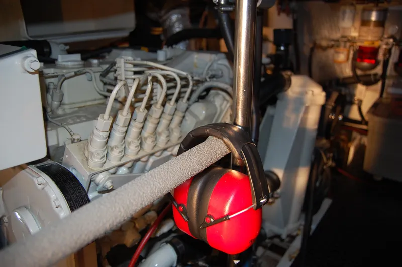 Slide: The Image of Engine room of 2002 Eagle Pilothouse with red earmuffs hanging on a pipe. - 22