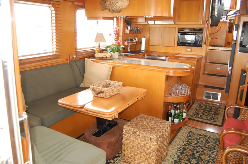 Slide: The Image of Luxurious interior of a 2002 Eagle Pilothouse yacht with cozy seating and modern kitchen. - 25
