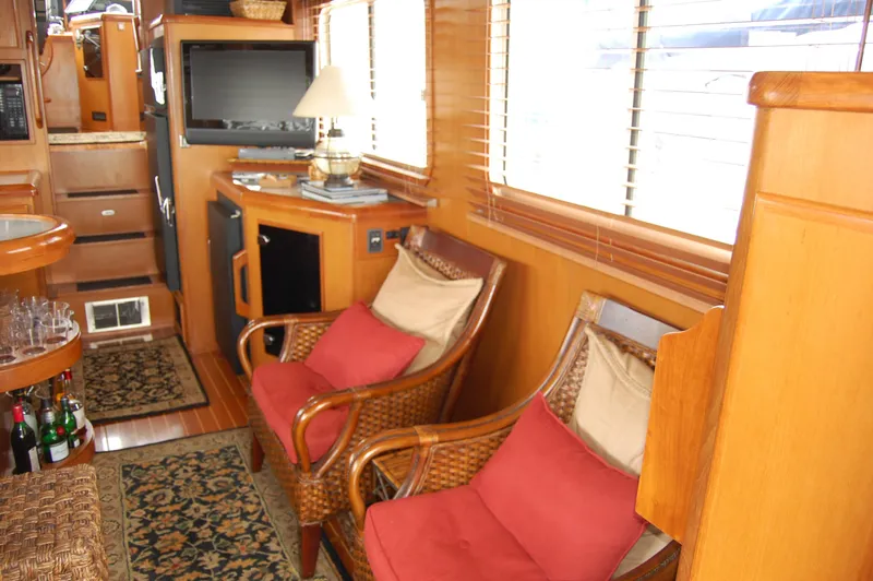 Slide: The Image of Interior of 2002 Eagle Pilothouse with cozy seating, TV, and wooden decor. - 26
