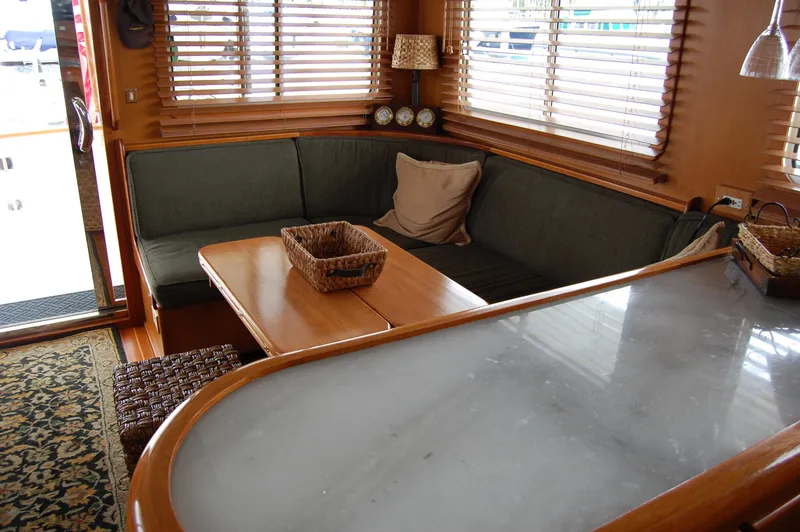Slide: The Image of Interior of 2002 Eagle Pilothouse with cozy seating and wooden accents. - 29