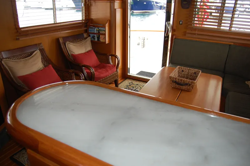 Slide: The Image of Interior of 2002 Eagle Pilothouse yacht with cozy seating and wooden accents. - 30