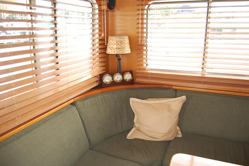 Slide: The Image of Cozy interior of 2002 Eagle Pilothouse with cushioned seating and wooden blinds. - 31