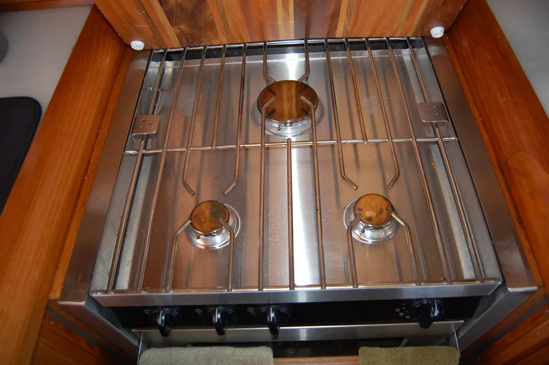Slide: The Image of Stainless steel stove in 2002 Eagle Pilothouse kitchen, featuring three burners. - 33