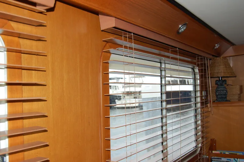 Slide: The Image of Interior of 2002 Eagle Pilothouse with wooden blinds and window view. - 34
