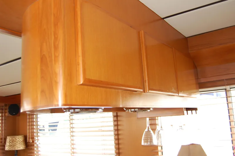 Slide: The Image of Wooden cabinets in a 2002 Eagle Pilothouse interior with hanging wine glasses. - 35