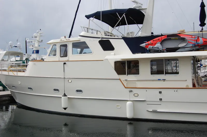 Slide: The Image of 2002 Eagle Pilothouse yacht docked at marina, featuring sleek design and modern amenities. - 4