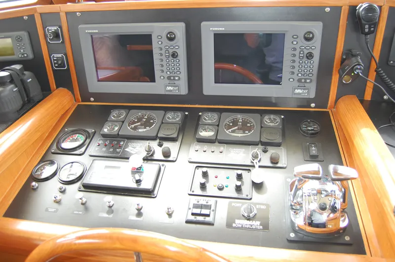 Slide: The Image of Control panel of a 2002 Eagle Pilothouse boat with navigation screens and gauges. - 41