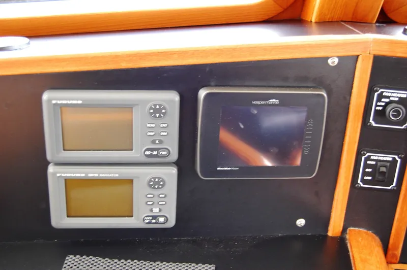 Slide: The Image of Control panel of a 2002 Eagle Pilothouse with navigation displays and instruments. - 42