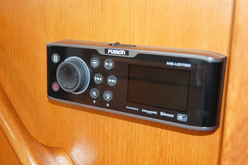 Slide: The Image of Audio control panel on a 2002 Eagle Pilothouse boat, featuring Fusion MS-UD750. - 44