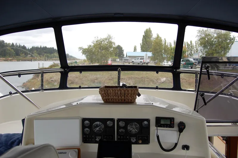 Slide: The Image of Pilothouse interior of 2002 Eagle boat with control panel and outdoor view. - 49