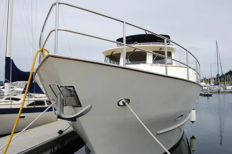 Slide: The Image of 2002 Eagle Pilothouse boat docked in a marina, front view. - 5