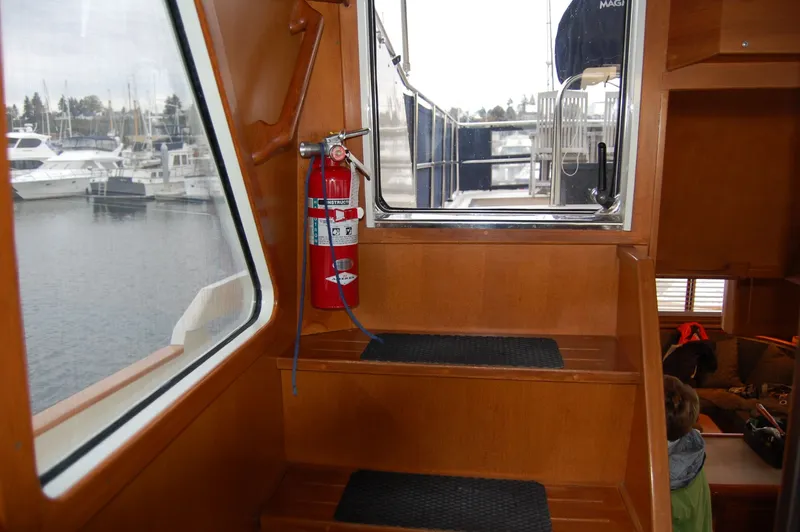 Slide: The Image of Interior of 2002 Eagle Pilothouse boat with stairs and fire extinguisher. - 8