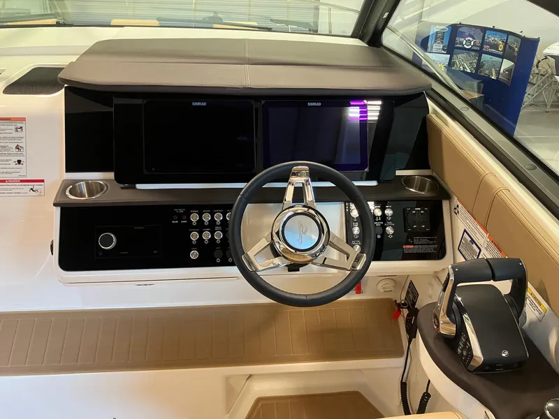 Slide: The Image of 2025 Sea Ray Sundancer 320 helm with modern controls and dual displays. - 12