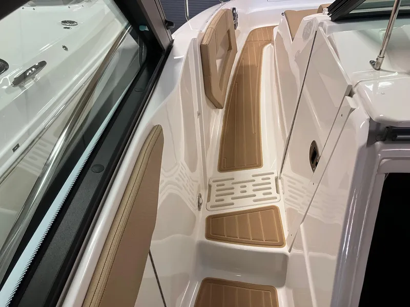 Slide: The Image of 2025 Sea Ray Sundancer 320 boat deck with sleek design and wood accents. - 19