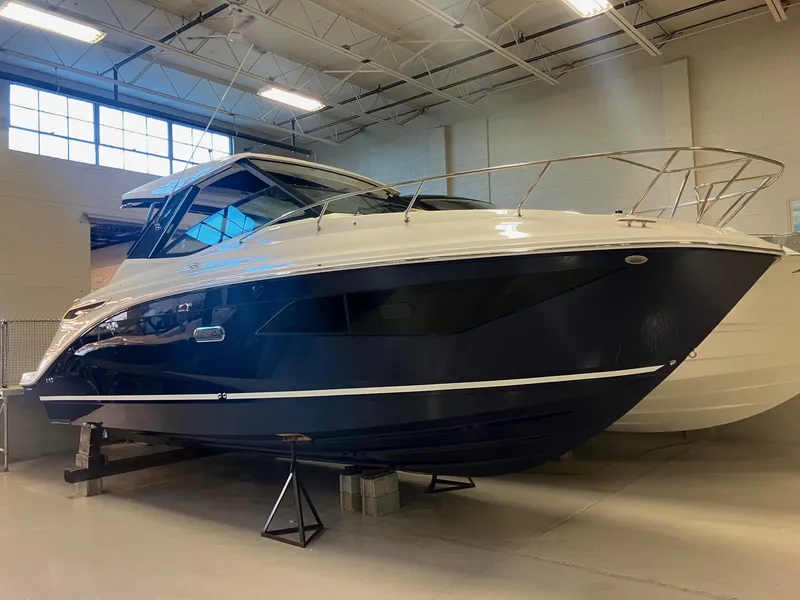 Slide: The Image of 2025 Sea Ray Sundancer 320 boat displayed indoors, showcasing sleek design and modern features. - 3