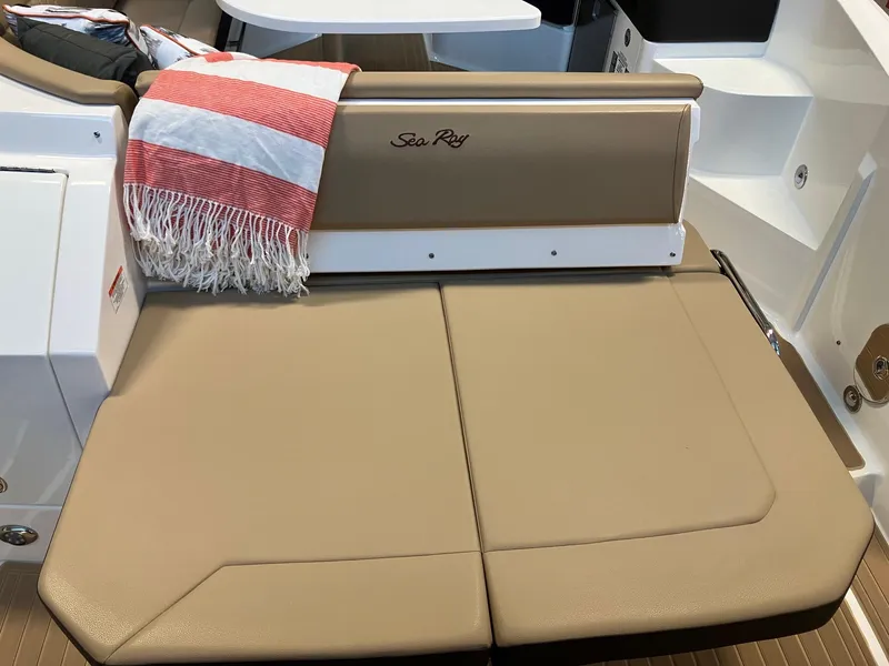 Slide: The Image of 2025 Sea Ray Sundancer 320 boat seating with red-striped blanket. - 6