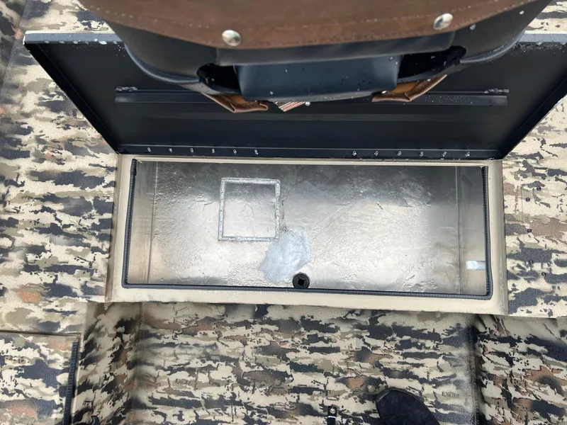 Slide: The Image of 2025 Excel 1751 River Warrior boat interior with open storage compartment. - 10