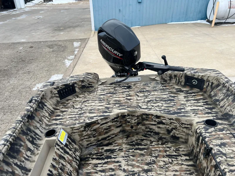 Slide: The Image of 2025 Excel 1751 River Warrior boat with camouflage design and Mercury outboard motor. - 14